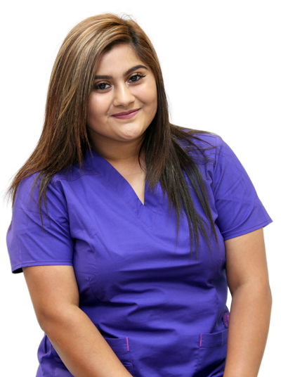 Physical therapist in purple scrubs looking at camera