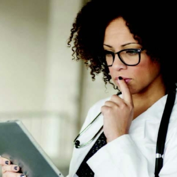 Woman holding tablet using clinical analysis software